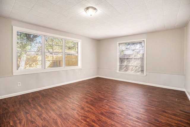 unfurnished room featuring dark wood-type flooring