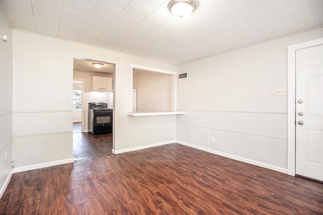 empty room featuring dark hardwood / wood-style flooring