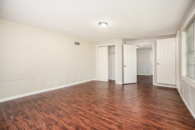 unfurnished bedroom featuring dark wood-type flooring