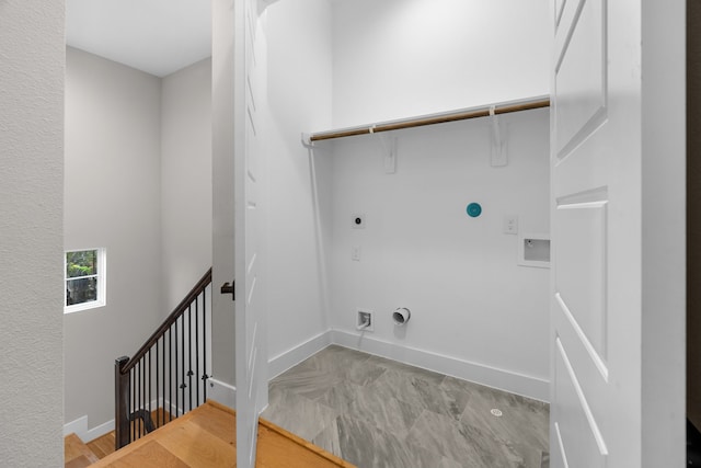 laundry room featuring hookup for an electric dryer, hookup for a gas dryer, hookup for a washing machine, and light hardwood / wood-style flooring