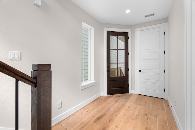 foyer entrance with light hardwood / wood-style floors and plenty of natural light