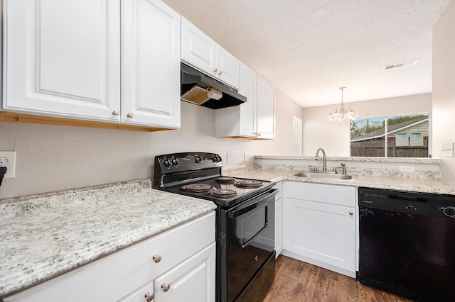 kitchen featuring pendant lighting, white cabinetry, sink, and black appliances