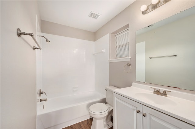 full bathroom with hardwood / wood-style floors, vanity, toilet, and shower / tub combination