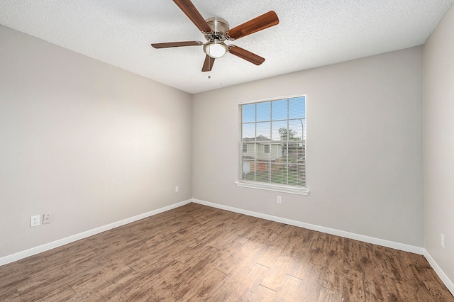 spare room with hardwood / wood-style flooring, ceiling fan, and a textured ceiling