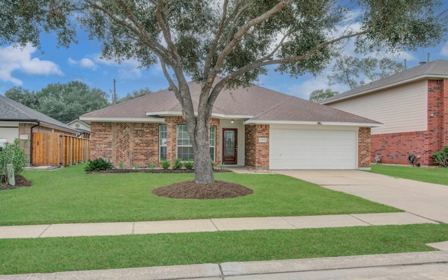 ranch-style house featuring a front yard and a garage