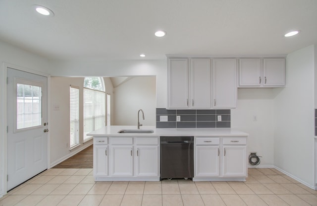 kitchen featuring light tile patterned flooring, white cabinetry, and sink