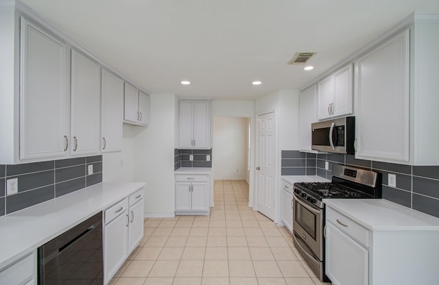 kitchen with backsplash, stainless steel appliances, light tile patterned floors, white cabinets, and wine cooler