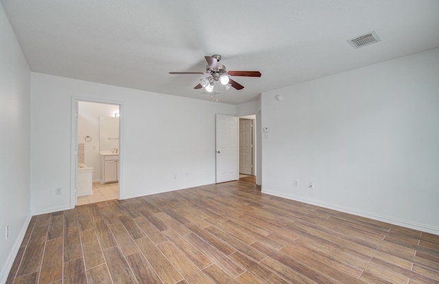 unfurnished room with light wood-type flooring and ceiling fan