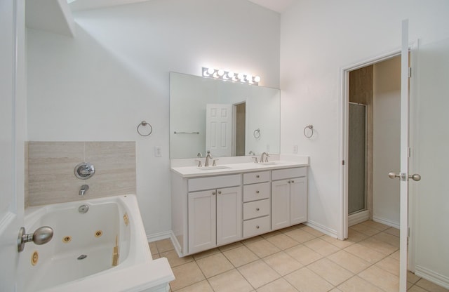 bathroom featuring tile patterned flooring, vanity, and shower with separate bathtub