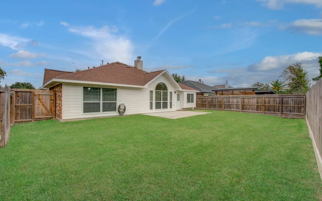 back of house featuring a patio and a lawn