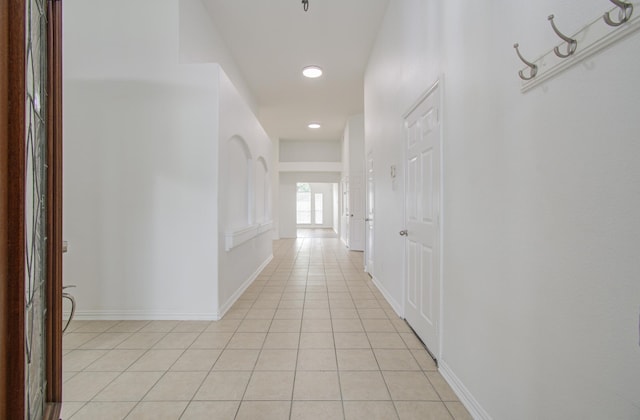 hall featuring light tile patterned floors