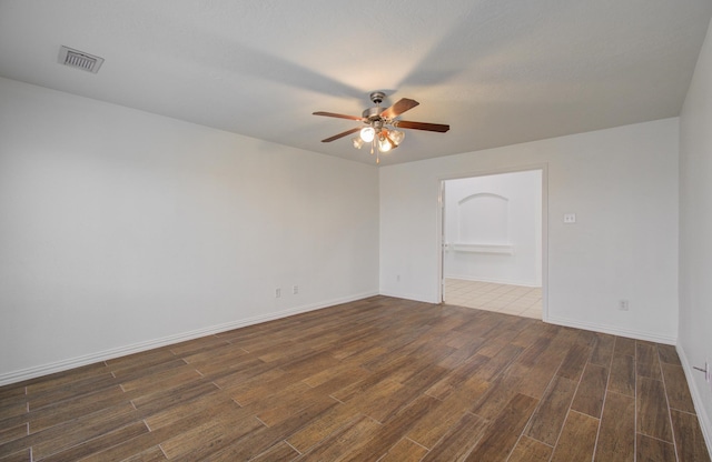 spare room featuring dark hardwood / wood-style floors and ceiling fan