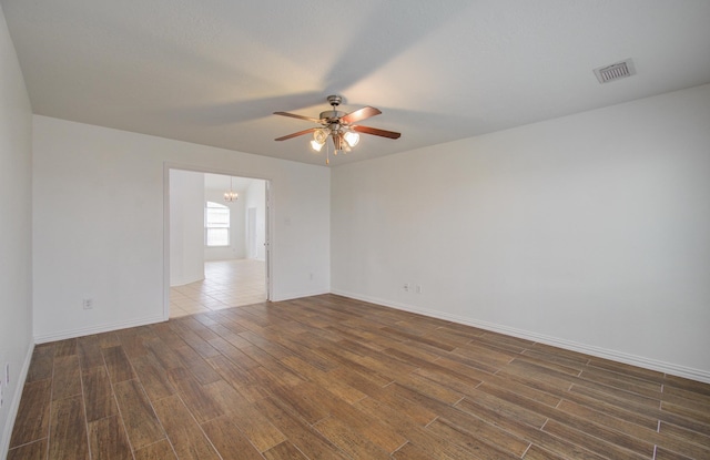 spare room with dark hardwood / wood-style floors and ceiling fan