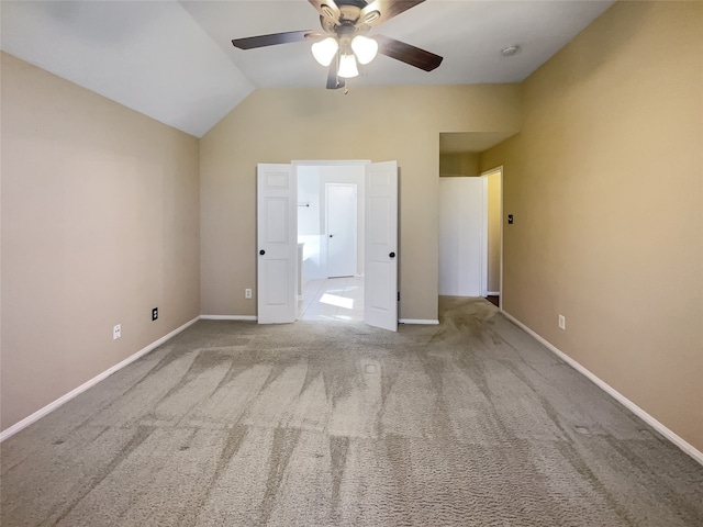 unfurnished bedroom featuring light colored carpet, ceiling fan, and lofted ceiling