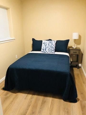 bedroom with wood-type flooring