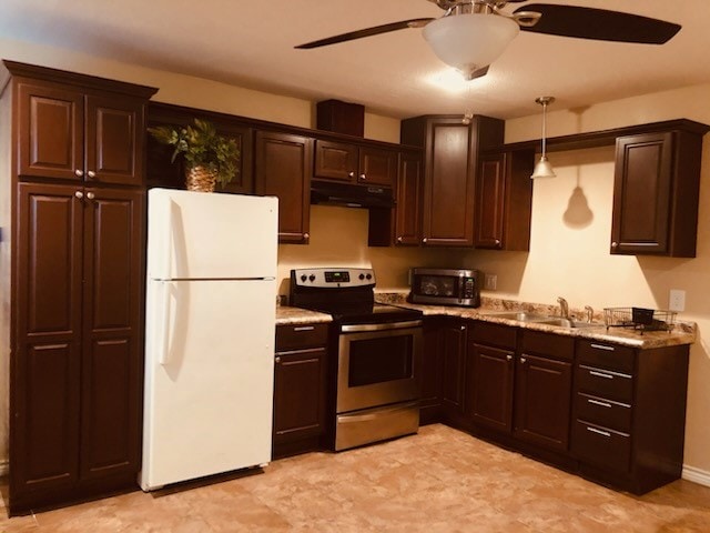 kitchen featuring ceiling fan, sink, white fridge, decorative light fixtures, and stainless steel electric stove