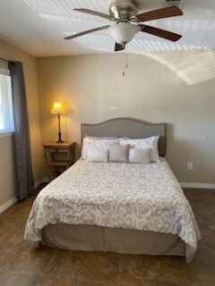 bedroom featuring ceiling fan and tile patterned flooring