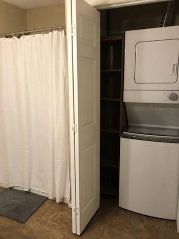 laundry area featuring stacked washer and dryer