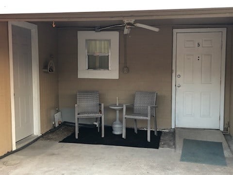 view of exterior entry with ceiling fan