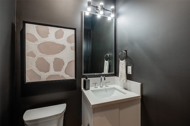 bathroom with toilet and vanity