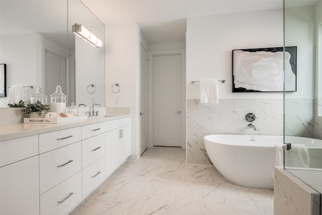 bathroom with vanity, a bath, and tile walls