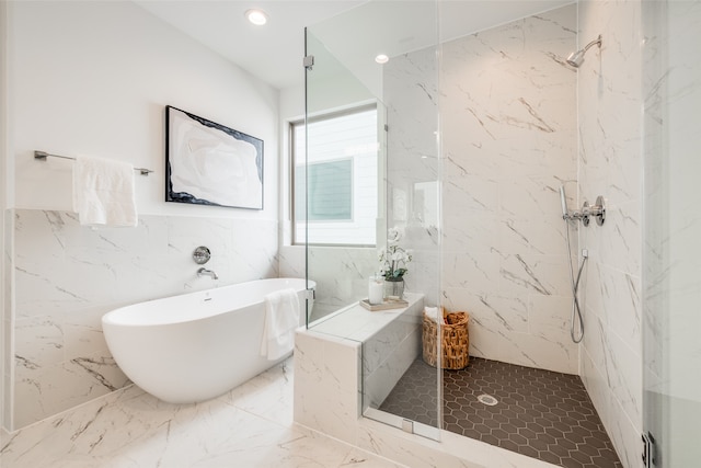 bathroom with a marble finish shower, recessed lighting, marble finish floor, and a freestanding tub