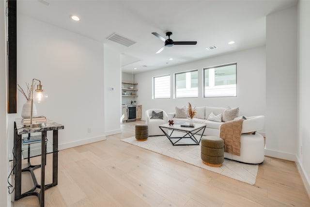 living room featuring beverage cooler, visible vents, recessed lighting, and light wood-style floors