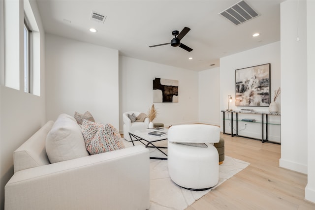 living room with light wood-type flooring and ceiling fan