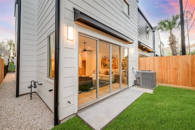 exterior space featuring cooling unit, a yard, and fence