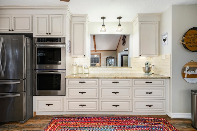 kitchen featuring light stone countertops, stainless steel appliances, dark hardwood / wood-style flooring, backsplash, and decorative light fixtures