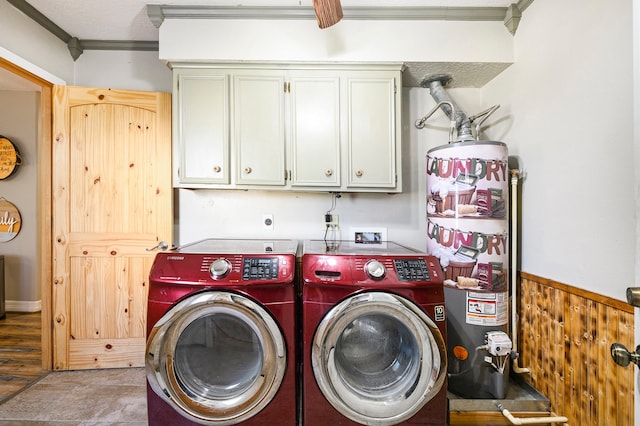 laundry room featuring washer and clothes dryer, cabinets, ornamental molding, light wood-type flooring, and water heater