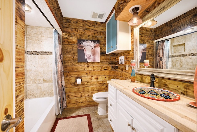 full bathroom with vanity, toilet, wooden walls, and shower / tub combo