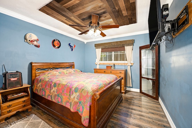 bedroom with ceiling fan, dark hardwood / wood-style flooring, wood ceiling, and crown molding