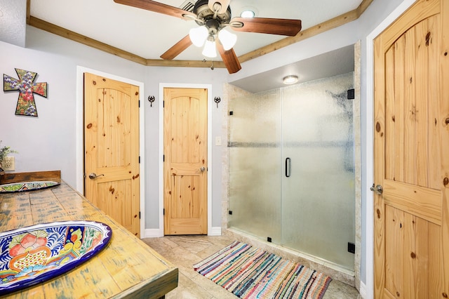 bathroom with tile patterned floors, a shower with door, and ceiling fan