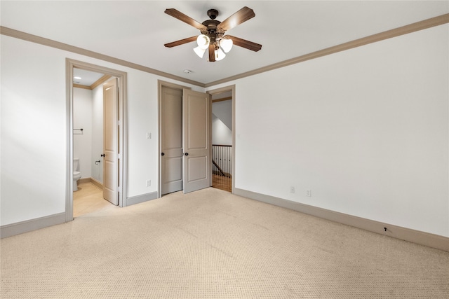 unfurnished bedroom featuring connected bathroom, ceiling fan, light carpet, and ornamental molding