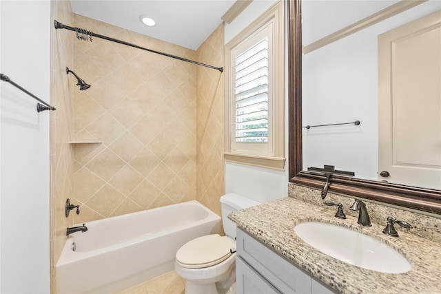 full bathroom featuring vanity, toilet, and tiled shower / bath combo