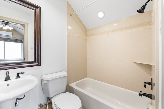 full bathroom featuring tiled shower / bath combo, toilet, lofted ceiling, and sink