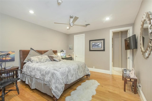 bedroom with ceiling fan and light hardwood / wood-style flooring