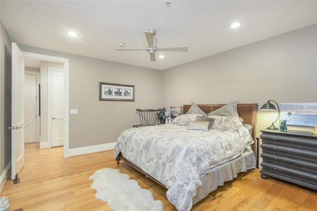 bedroom with ceiling fan and light hardwood / wood-style floors