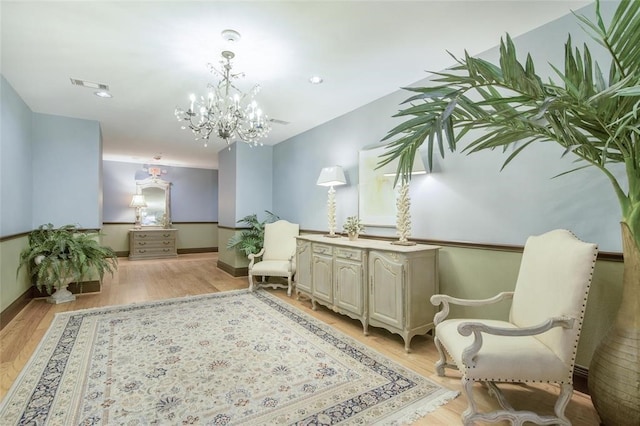 living area featuring a chandelier and light wood-type flooring