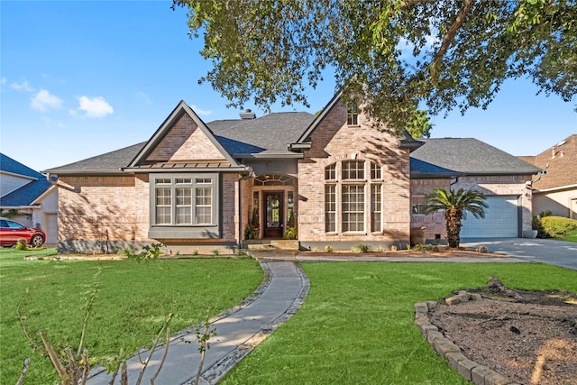 view of front of property with a garage and a front yard