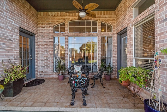 view of exterior entry with ceiling fan