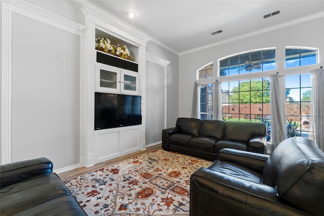 living room featuring wood-type flooring and crown molding