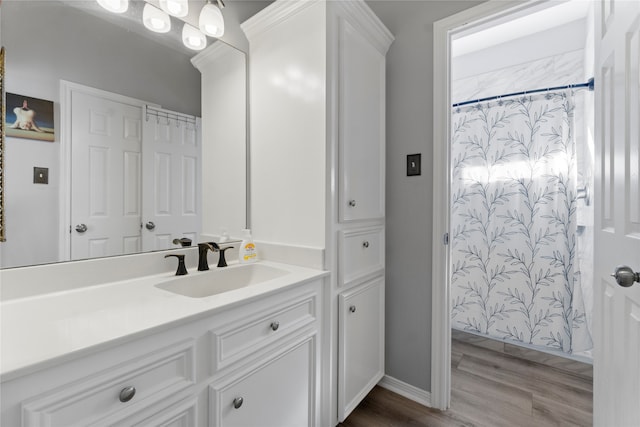 bathroom with hardwood / wood-style flooring and vanity