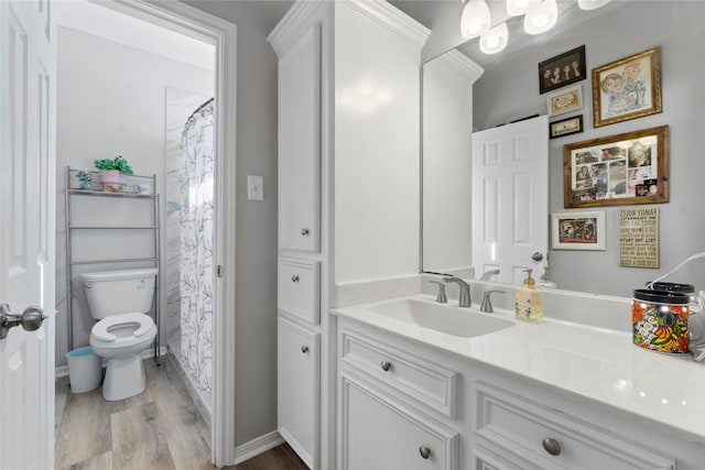 bathroom featuring curtained shower, vanity, wood-type flooring, and toilet