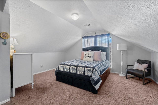 carpeted bedroom with a textured ceiling and vaulted ceiling