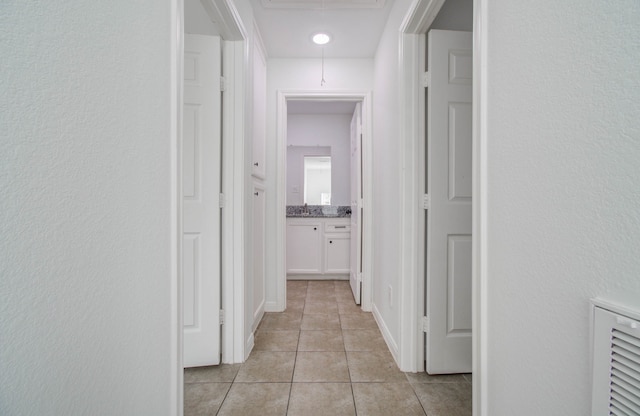 corridor with light tile patterned floors