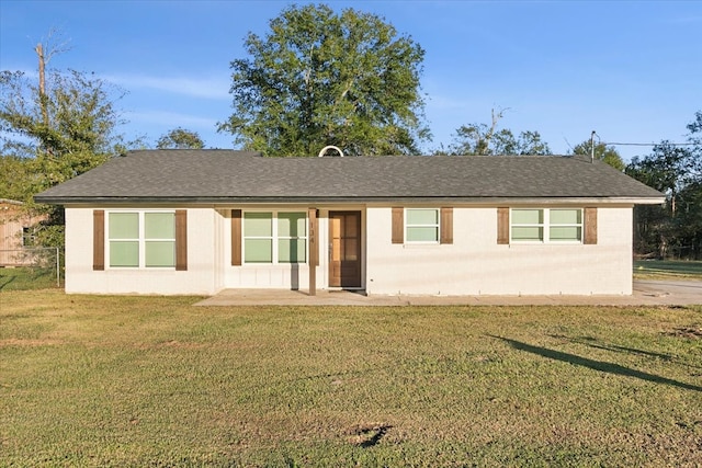 rear view of house featuring a lawn