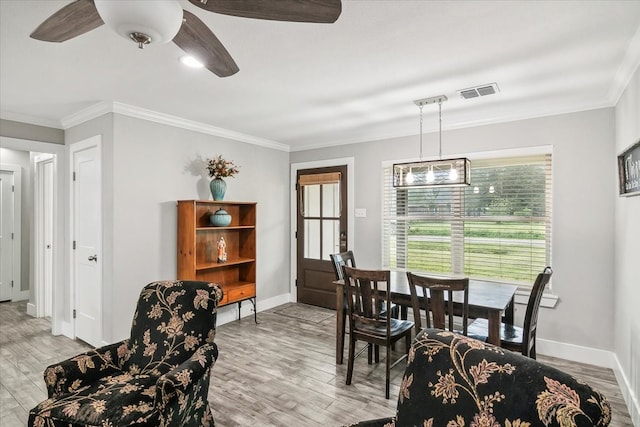 dining space featuring ceiling fan, light hardwood / wood-style floors, and ornamental molding