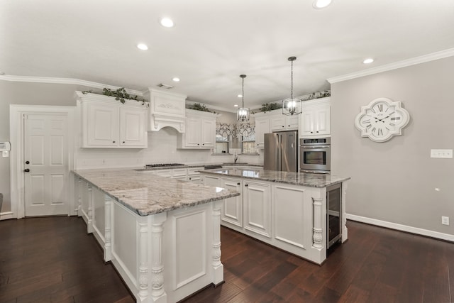 kitchen featuring a center island, light stone counters, white cabinetry, and appliances with stainless steel finishes